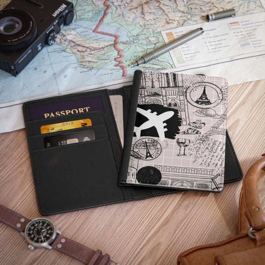 Passport, passport holder, camera, map, pen on a wooden surface