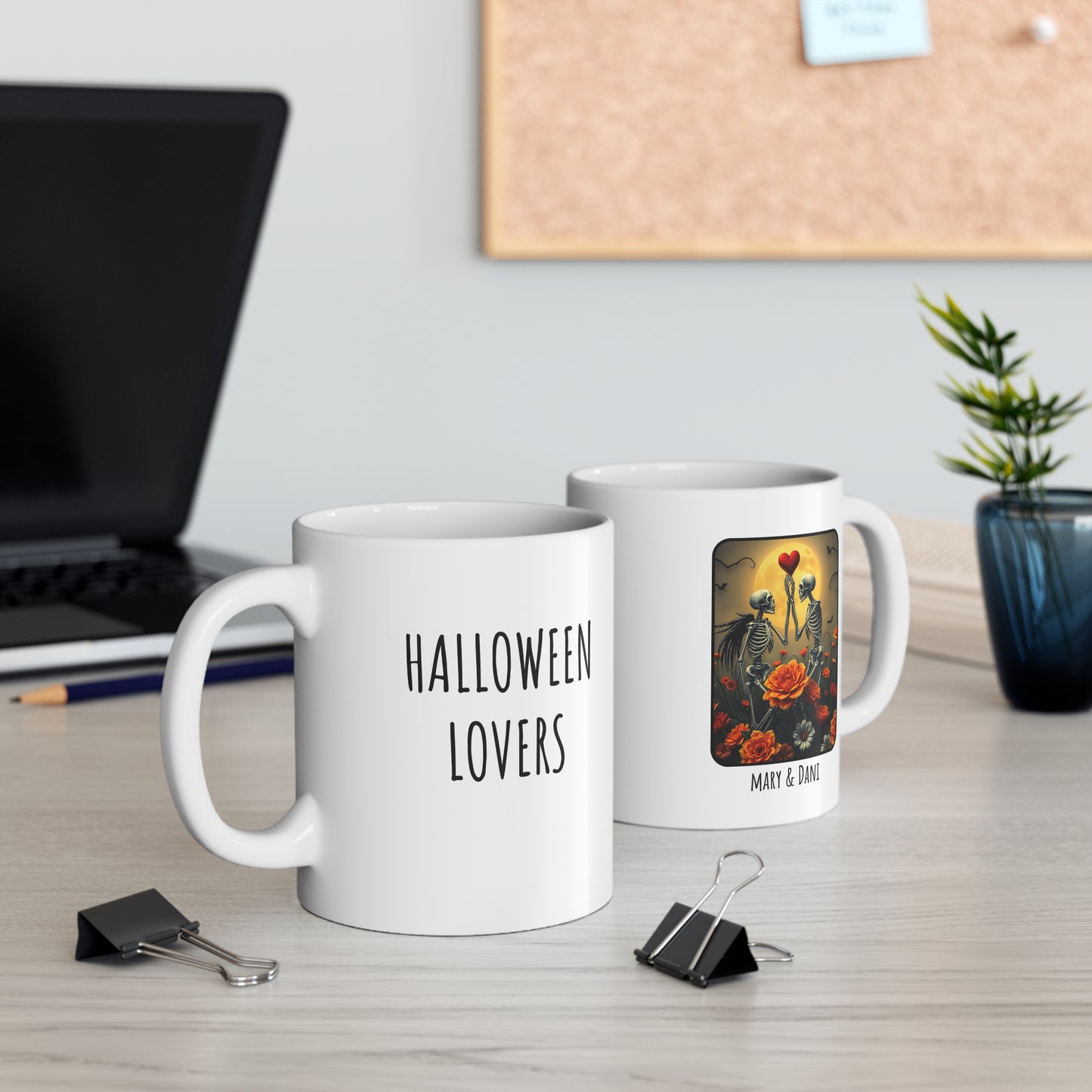 Two mugs on a desk with one labeled 'Halloween Lovers' and the other featuring a floral design.
