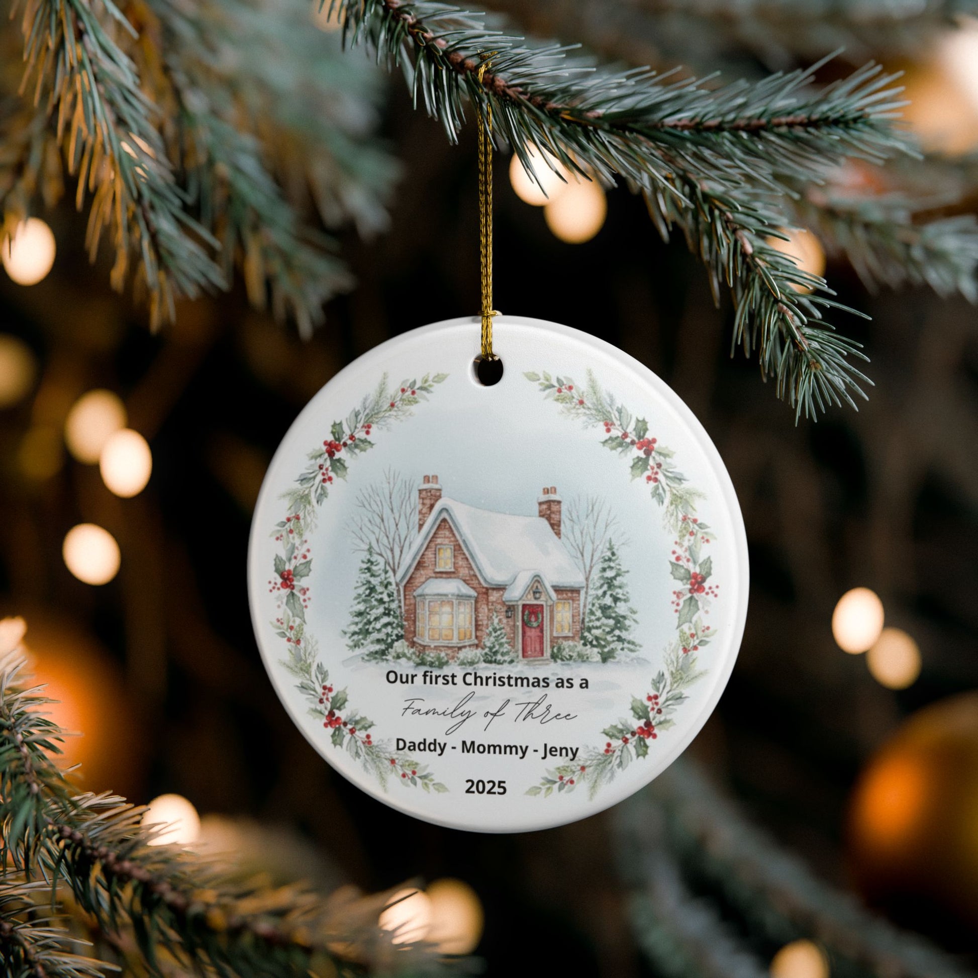 Christmas ornament with a house illustration and text on a tree branch.